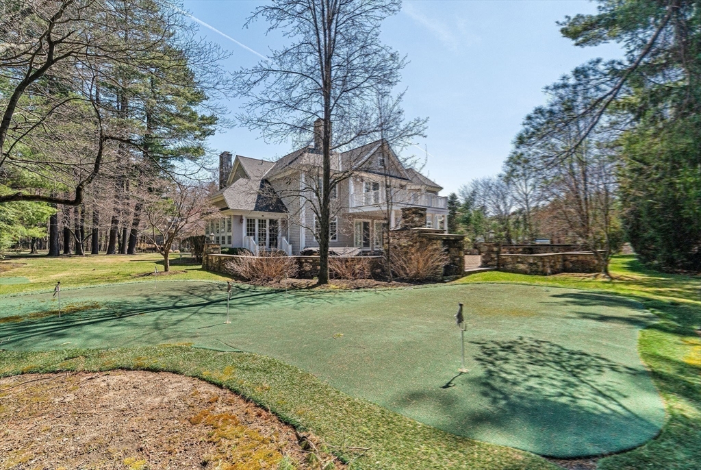 1 Stonefield Lane Wellesley, MA 02482 - Photo 27 of 30 a view of a big house with a big yard and potted plants