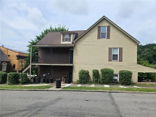 a front view of a house with a yard and porch
