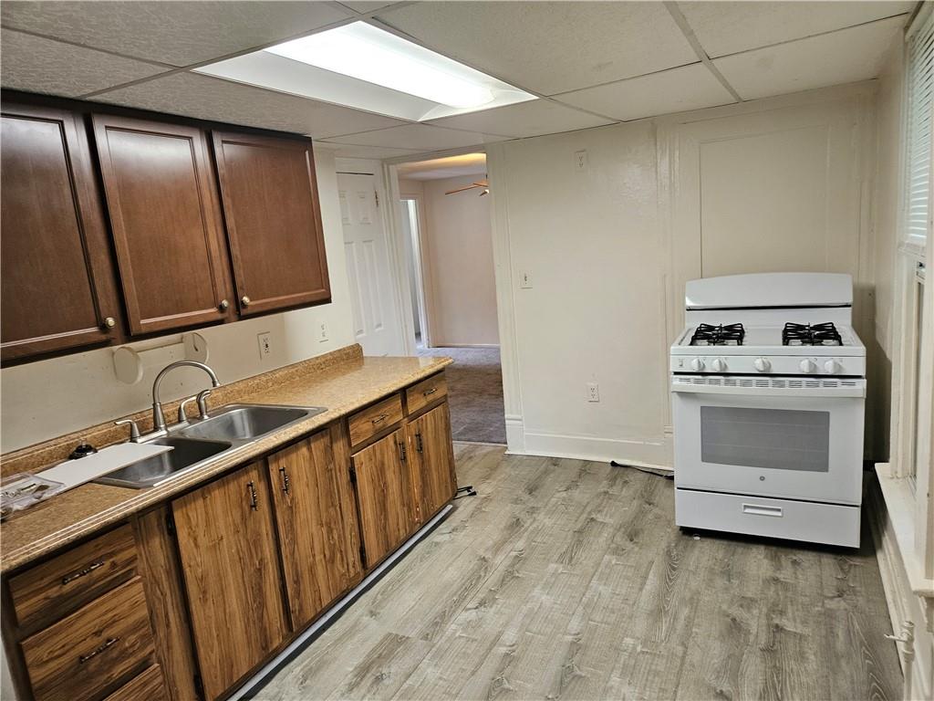 502 Center Avenue, Unit 2 Pitcairn, PA 15140 - Photo 13 of 28 a kitchen with a sink stove and cabinets