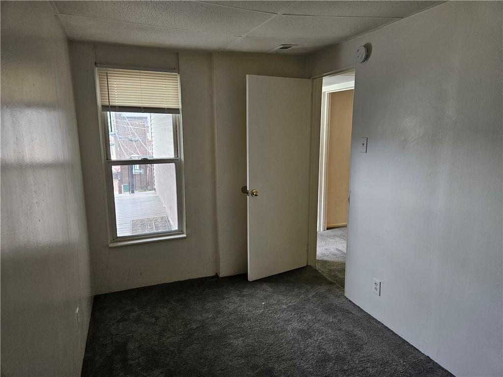 502 Center Avenue, Unit 2 Pitcairn, PA 15140 - Photo 25 of 28 an empty room with windows and closet