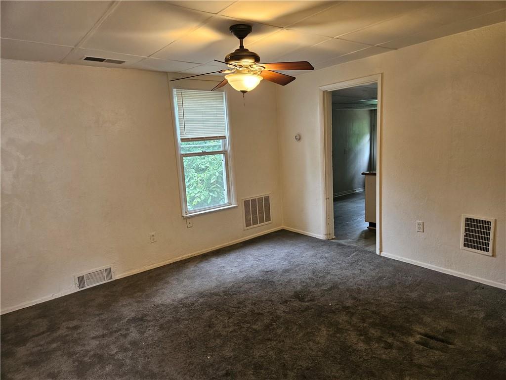 502 Center Avenue, Unit 2 Pitcairn, PA 15140 - Photo 9 of 28 an empty room with windows and a chandelier fan
