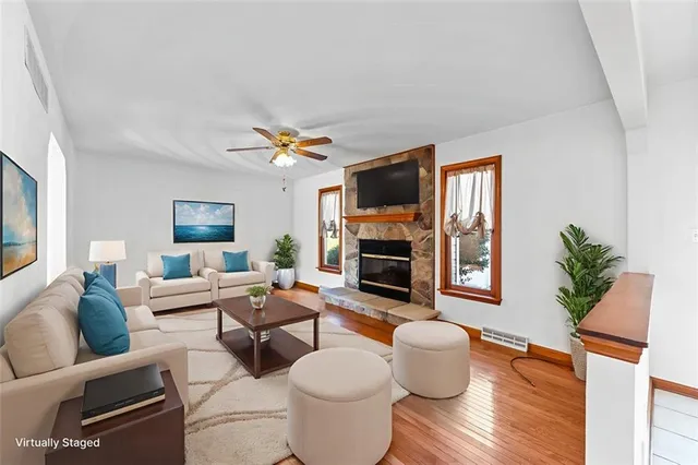 a living room with furniture and a fireplace