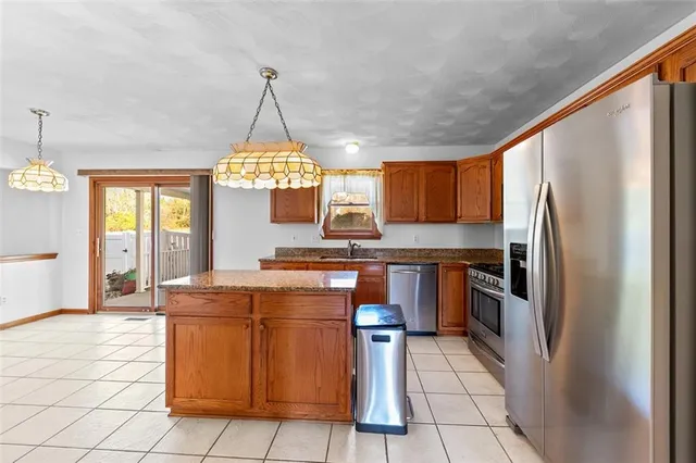 a kitchen with stainless steel appliances granite countertop a sink a counter space and cabinets