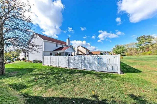 a view of a back yard of the house with a yard
