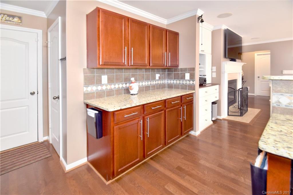 10010 Rocky Ford Club Road Charlotte, NC 28269 - Photo 11 of 24 a kitchen with stainless steel appliances granite countertop wooden cabinets a sink and dishwasher
