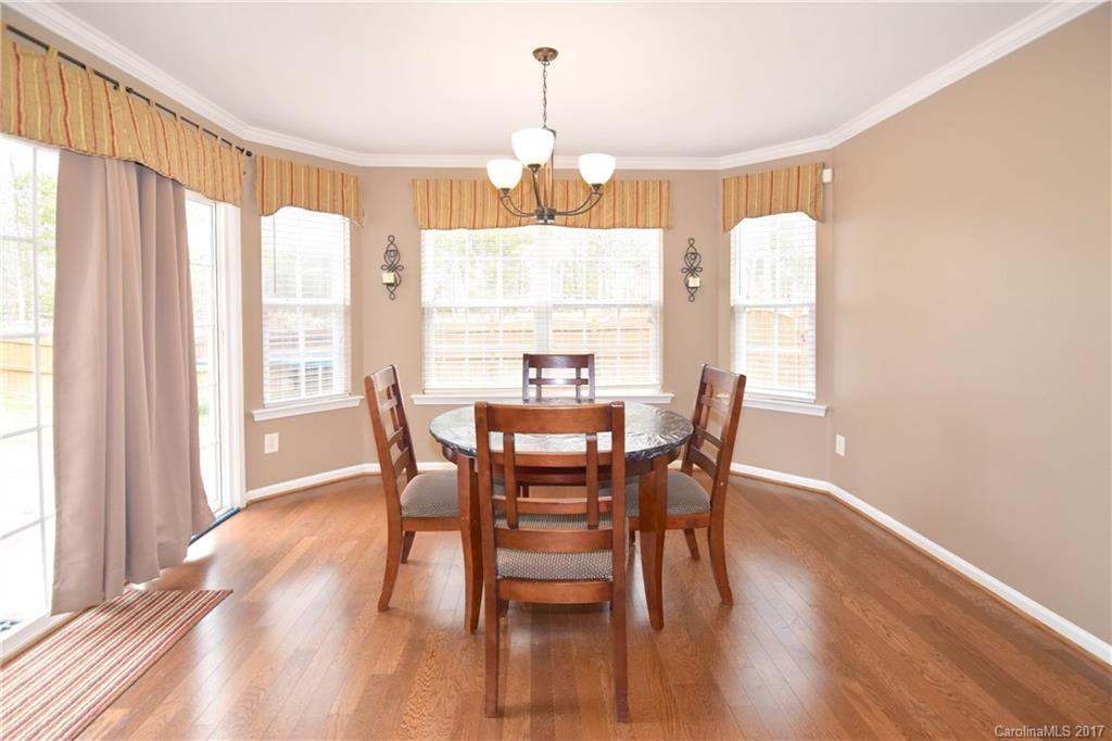 10010 Rocky Ford Club Road Charlotte, NC 28269 - Photo 12 of 24 a dining room with furniture window wooden floor