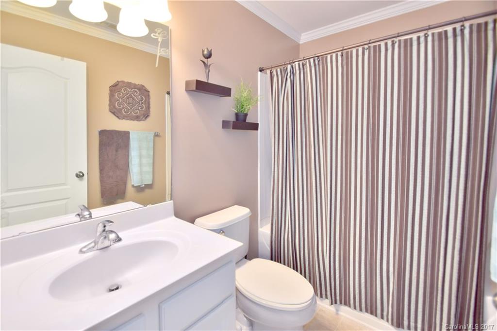 10010 Rocky Ford Club Road Charlotte, NC 28269 - Photo 14 of 24 a bathroom with a toilet a sink and a mirror