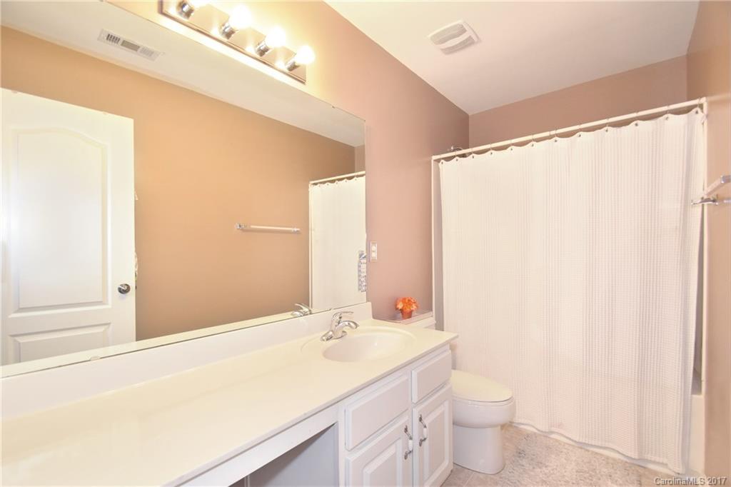 10010 Rocky Ford Club Road Charlotte, NC 28269 - Photo 16 of 24 a bathroom with a sink a toilet and a mirror
