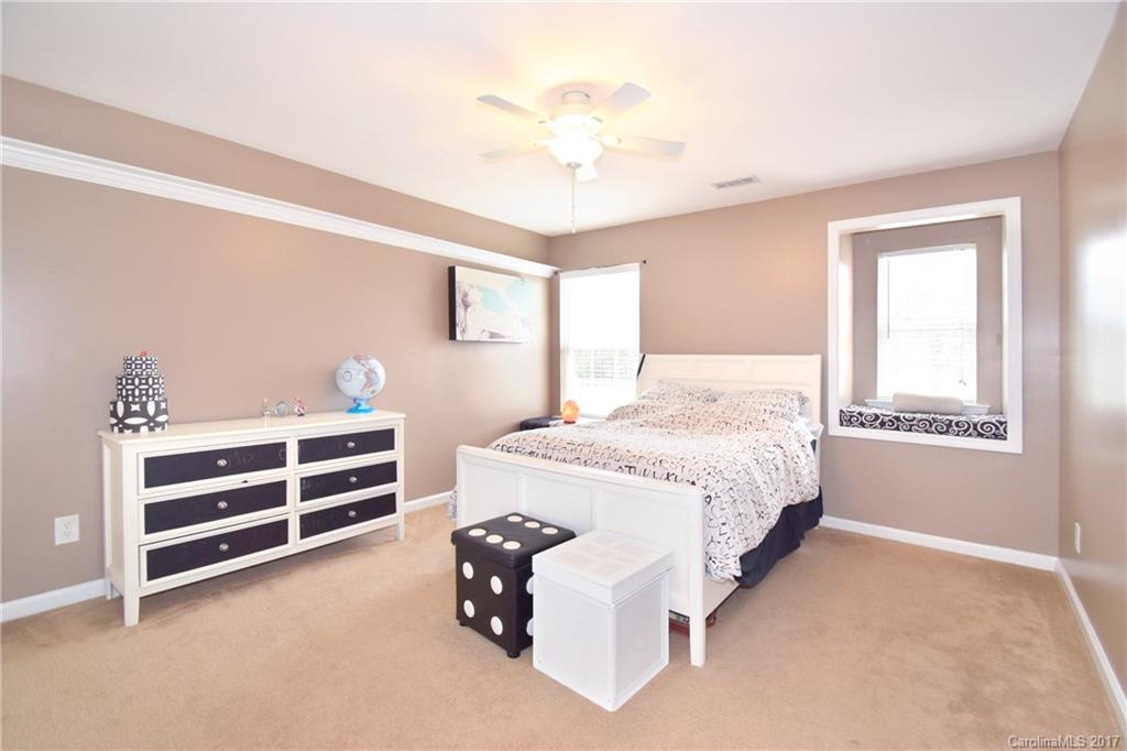 10010 Rocky Ford Club Road Charlotte, NC 28269 - Photo 18 of 24 a spacious bedroom with a bed and a cabinets