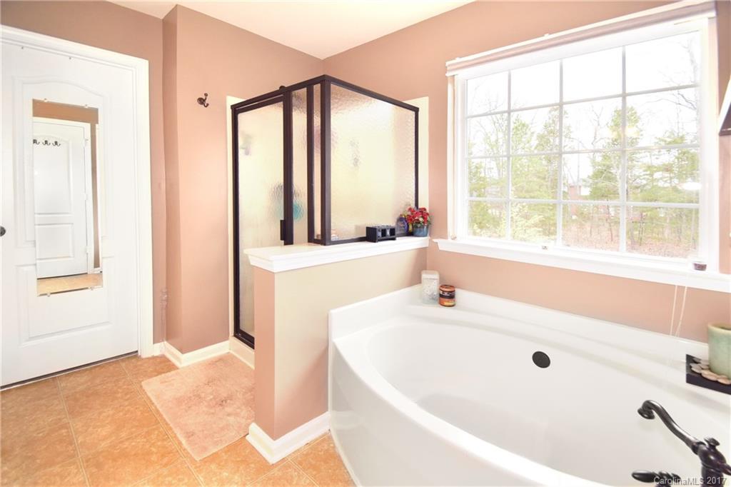 10010 Rocky Ford Club Road Charlotte, NC 28269 - Photo 21 of 24 a bathroom with a tub and a sink