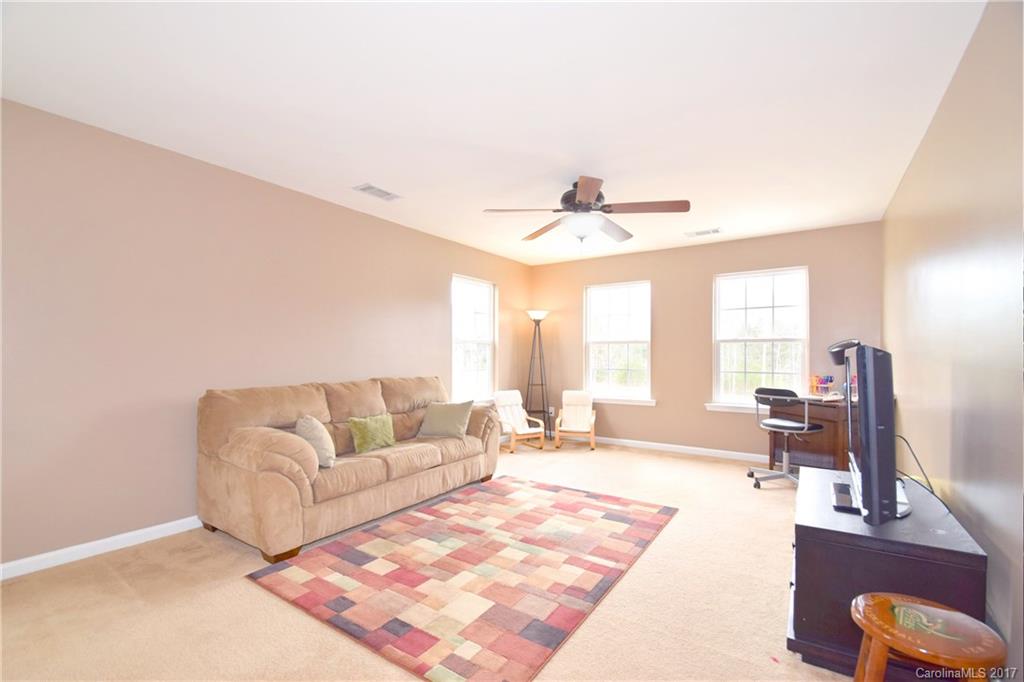 10010 Rocky Ford Club Road Charlotte, NC 28269 - Photo 22 of 24 a living room with furniture and a large window