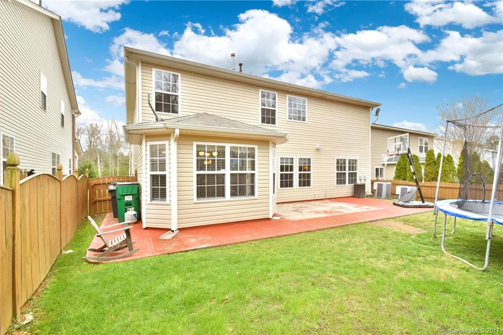 10010 Rocky Ford Club Road Charlotte, NC 28269 - Photo 24 of 24 a view of a house with a backyard and a patio