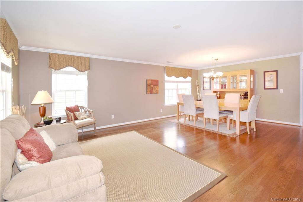 10010 Rocky Ford Club Road Charlotte, NC 28269 - Photo 5 of 24 a living room with furniture and a table with wooden floor