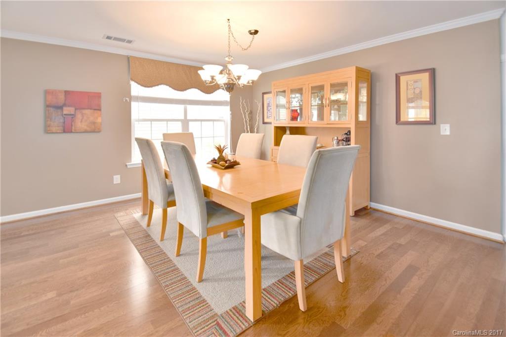 10010 Rocky Ford Club Road Charlotte, NC 28269 - Photo 6 of 24 a view of a dining room with furniture and a chandelier