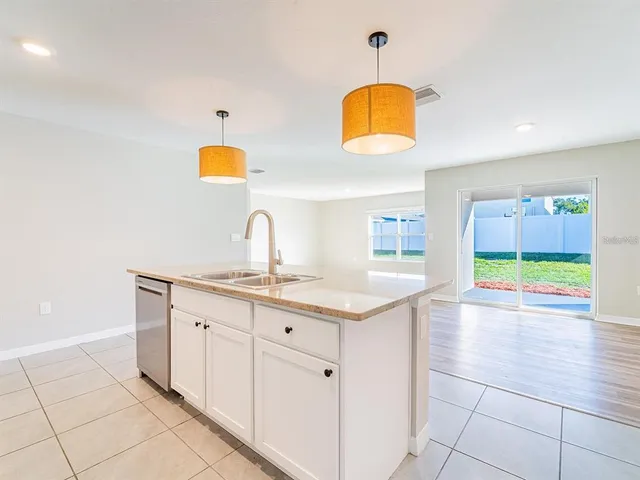 a kitchen with a sink cabinets and window