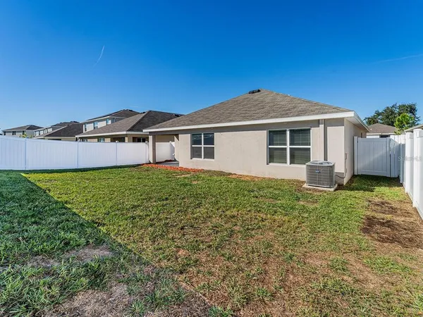 an aerial view of a city with lots of residential buildings and mountain view in back
