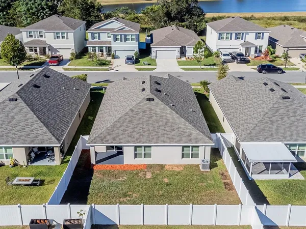 an aerial view of residential houses with outdoor space