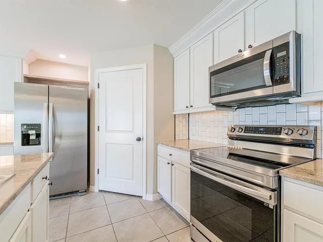 a kitchen with stainless steel appliances and cabinets