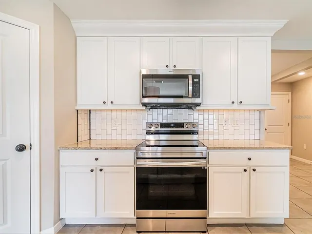 a kitchen with cabinets stainless steel appliances and a counter space