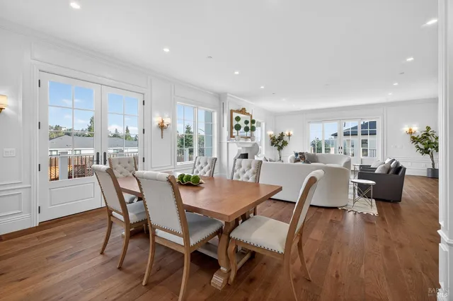 a living room with fireplace furniture and a large window