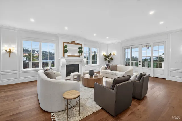 a living room with fireplace furniture and a wooden floor