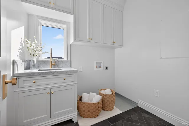 a kitchen with white cabinets and appliances