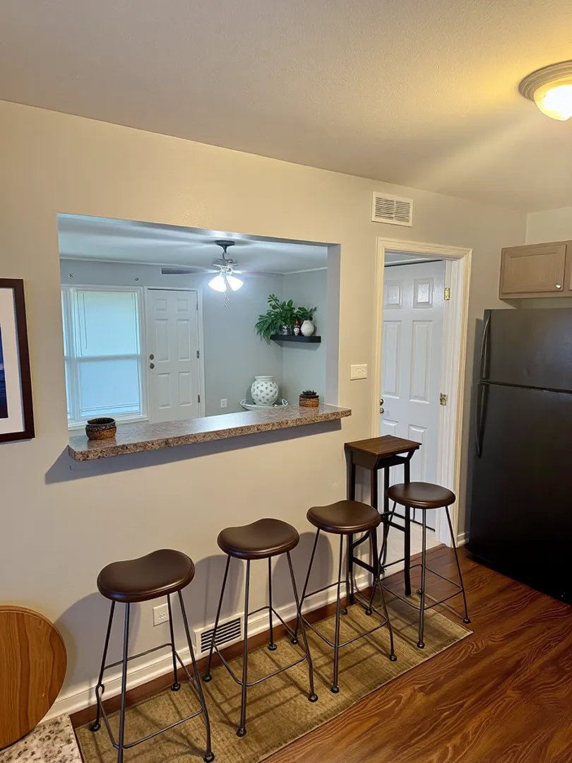 1212 East 151st Street Dolton, IL 60419 - Photo 12 of 24 a view of a dining room with furniture and wooden floor