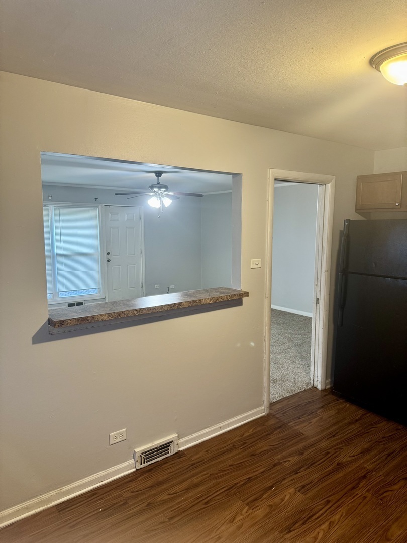 1212 East 151st Street Dolton, IL 60419 - Photo 13 of 24 a view of an empty room with wooden floor
