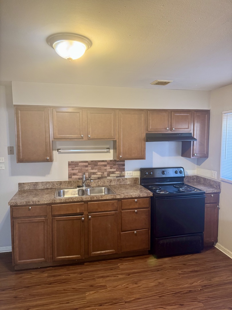 1212 East 151st Street Dolton, IL 60419 - Photo 14 of 24 a kitchen with stainless steel appliances granite countertop a sink and cabinets