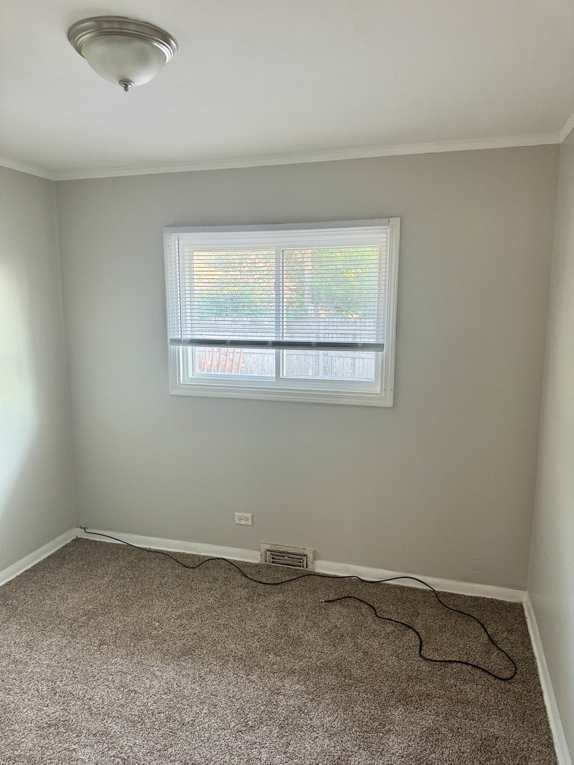 1212 East 151st Street Dolton, IL 60419 - Photo 9 of 24 an empty room with a window