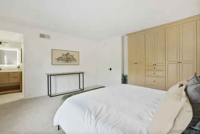 a bedroom with a bed and a painting