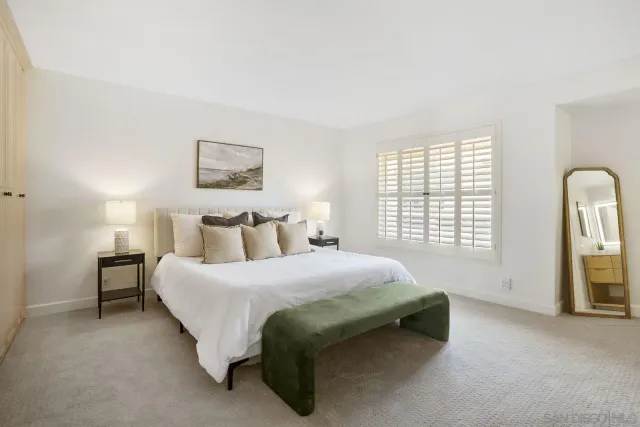 a spacious bedroom with a bed and a window