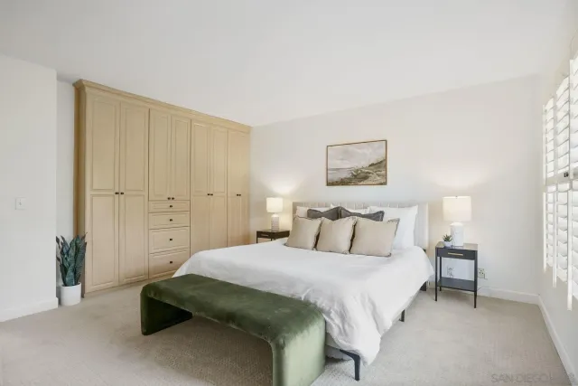 a bedroom with a bed a lamp and a window