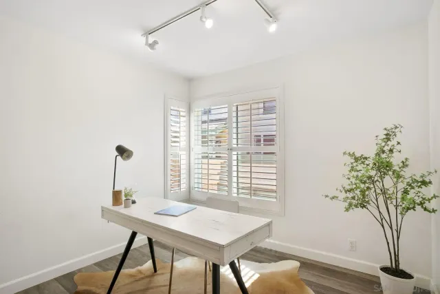 a view of a workspace with furniture and a potted plant