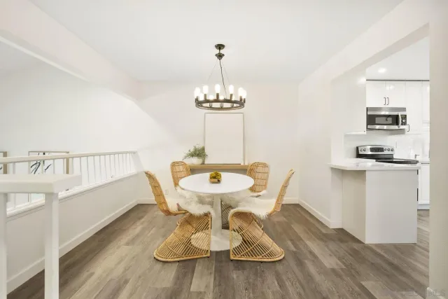 a view of a dining room with furniture wooden floor and a chandelier