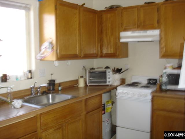 627 Roberts Street Reno, NV 89502 - Photo 4 of 5 a kitchen with a sink stove and cabinets