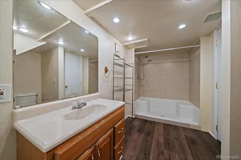 a bathroom with a sink a toilet and shower