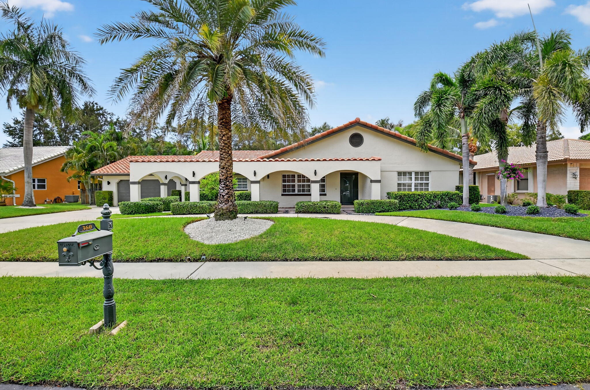 360 Northwest 53rd Street Boca Raton, FL 33487 - Photo 1 of 72 a front view of a house with a garden and plants