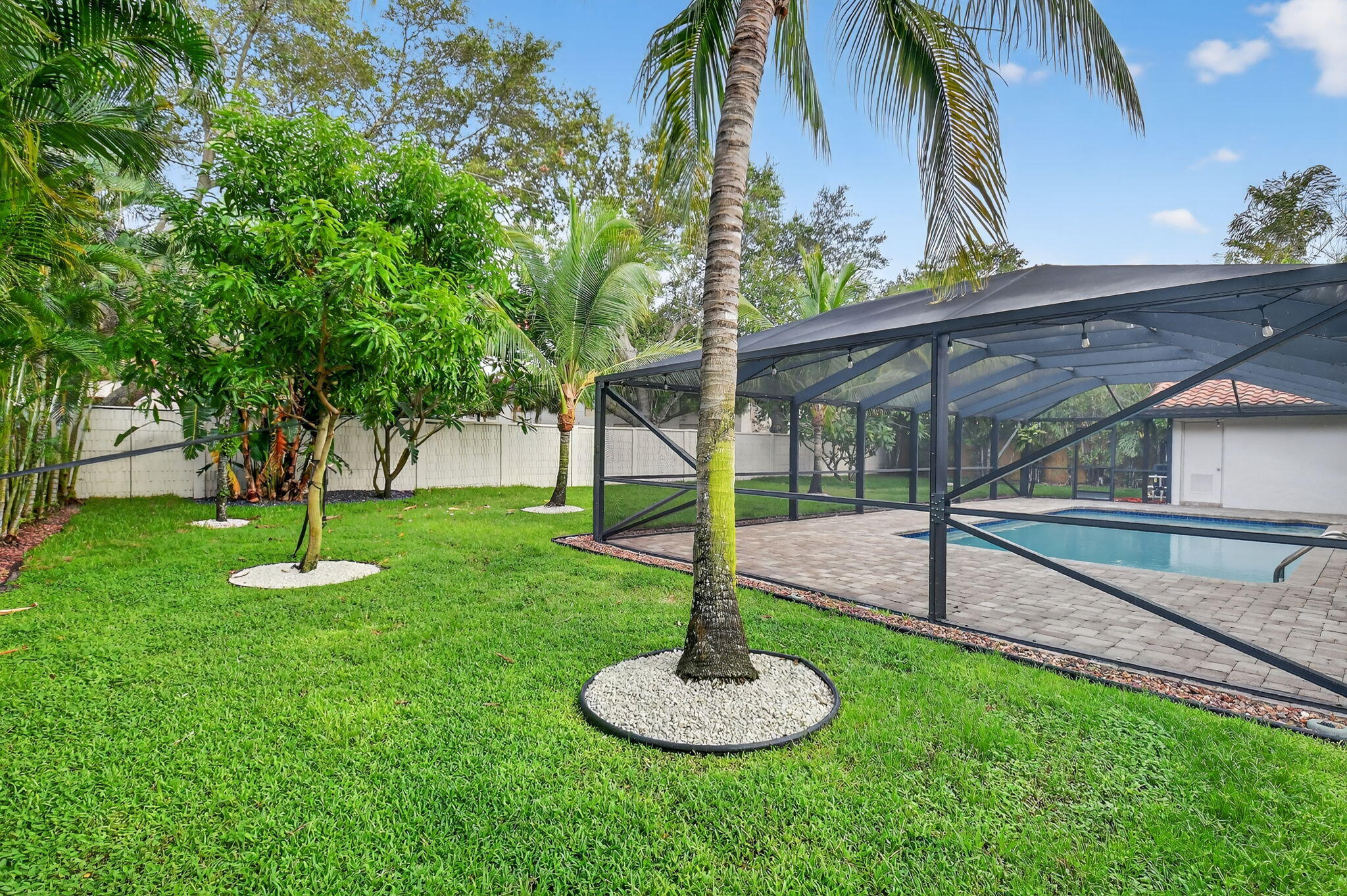 360 Northwest 53rd Street Boca Raton, FL 33487 - Photo 14 of 72 a swimming pool with lots of tress