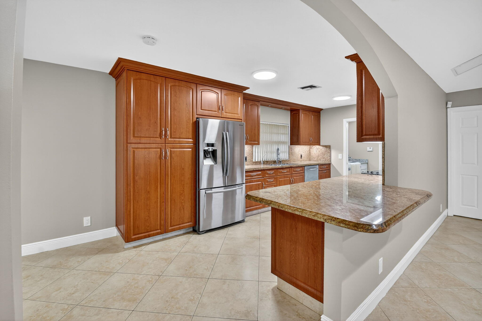 360 Northwest 53rd Street Boca Raton, FL 33487 - Photo 35 of 72 a kitchen with stainless steel appliances granite countertop a refrigerator a sink and a stove