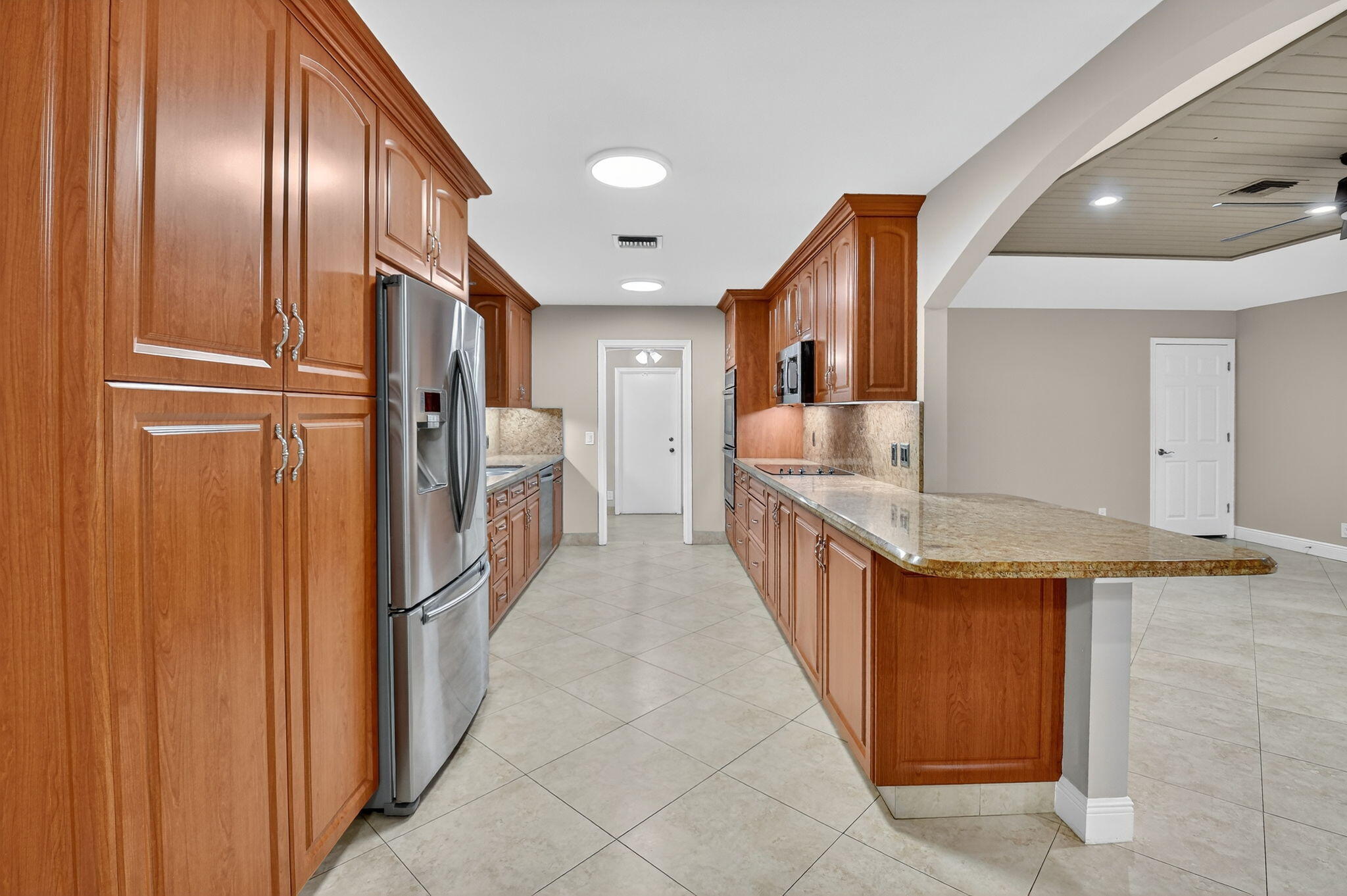 360 Northwest 53rd Street Boca Raton, FL 33487 - Photo 36 of 72 a kitchen with stainless steel appliances granite countertop a refrigerator and a sink