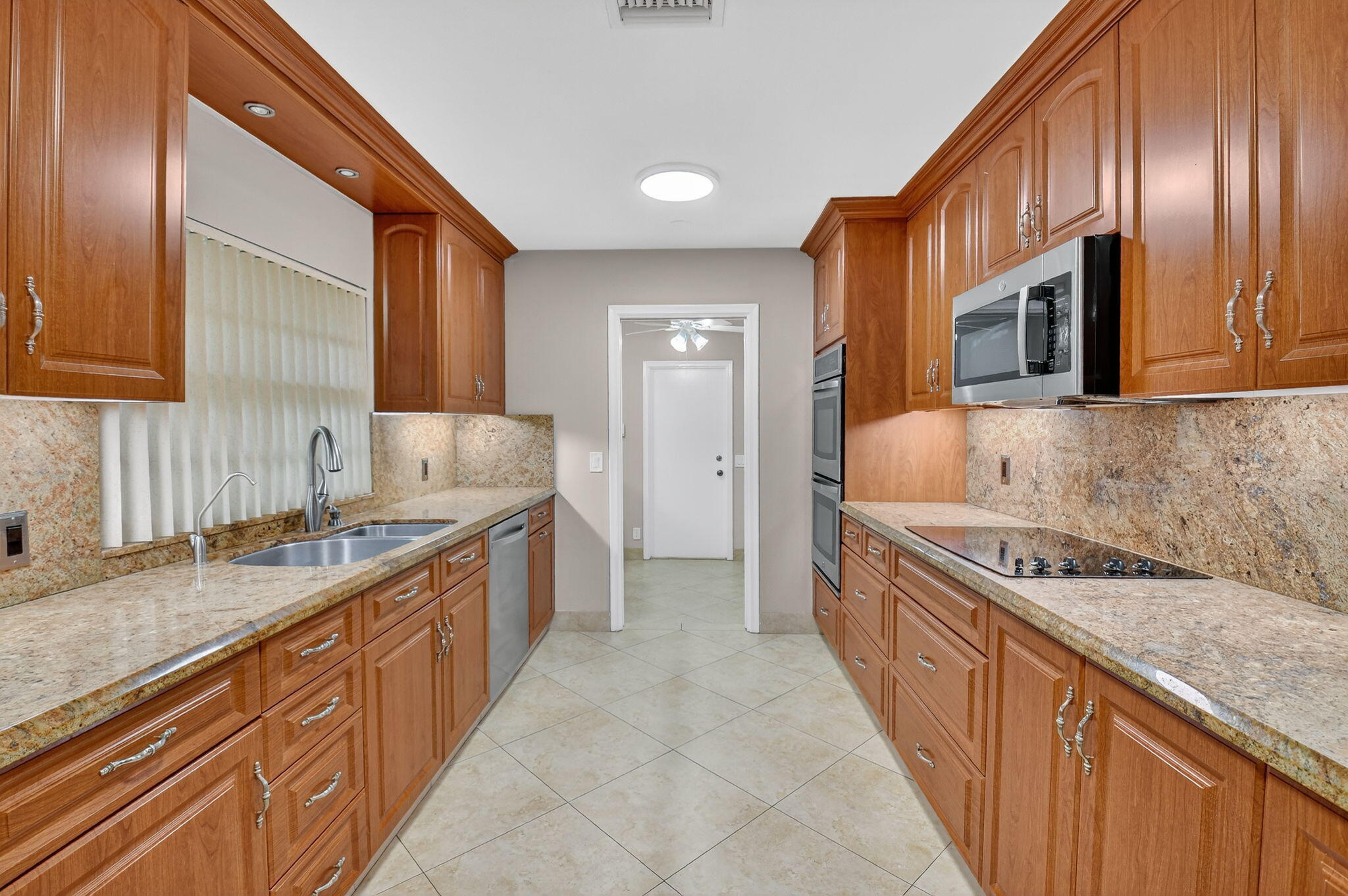 360 Northwest 53rd Street Boca Raton, FL 33487 - Photo 37 of 72 a kitchen with stainless steel appliances granite countertop a sink stove and cabinets