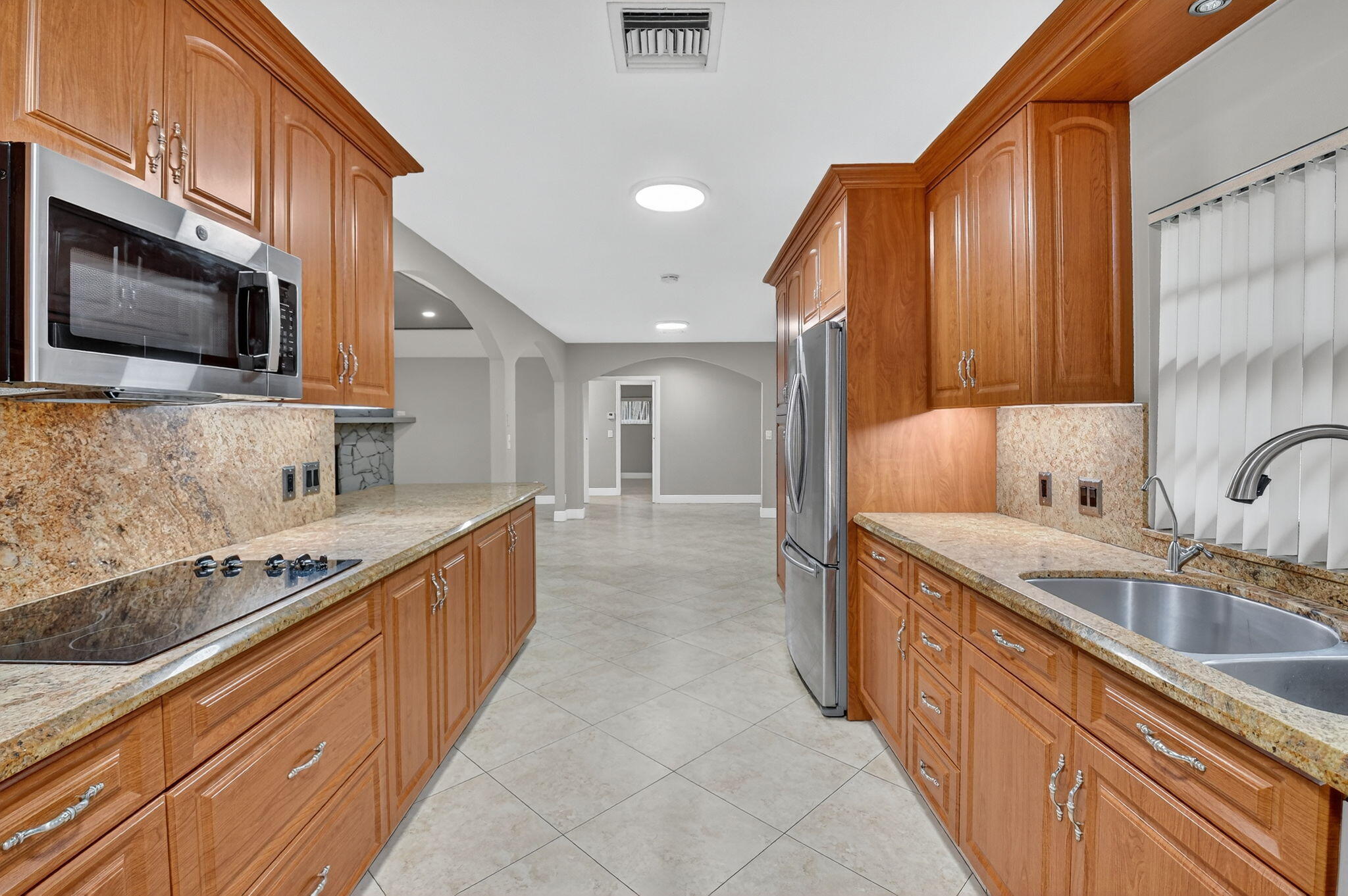 360 Northwest 53rd Street Boca Raton, FL 33487 - Photo 39 of 72 a large kitchen with stainless steel appliances granite countertop a sink stove and microwave
