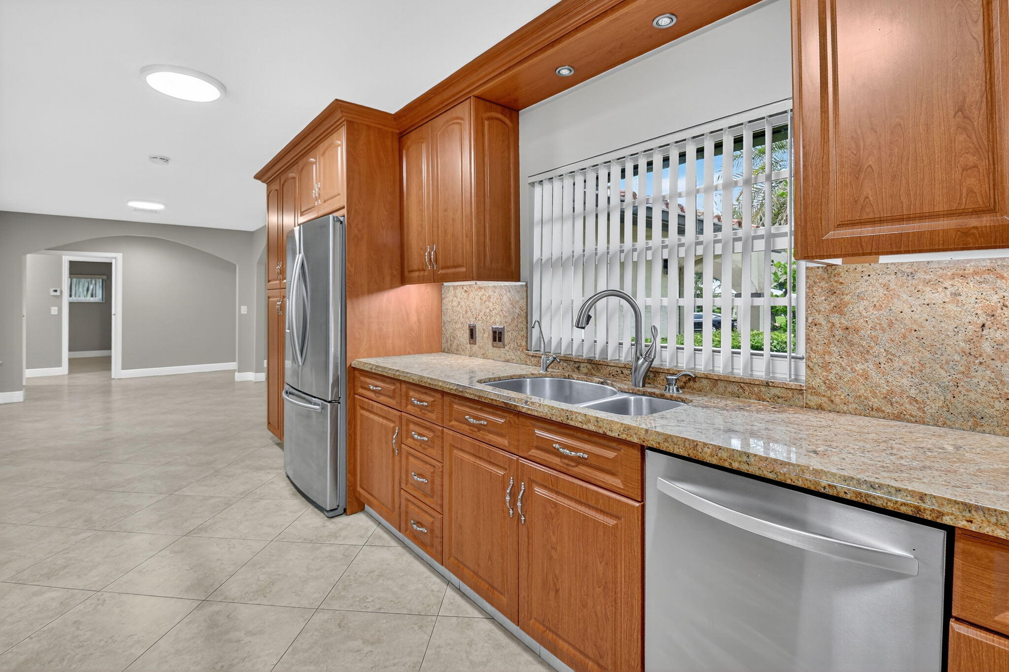 360 Northwest 53rd Street Boca Raton, FL 33487 - Photo 40 of 72 a kitchen with stainless steel appliances granite countertop a sink and a granite counter tops