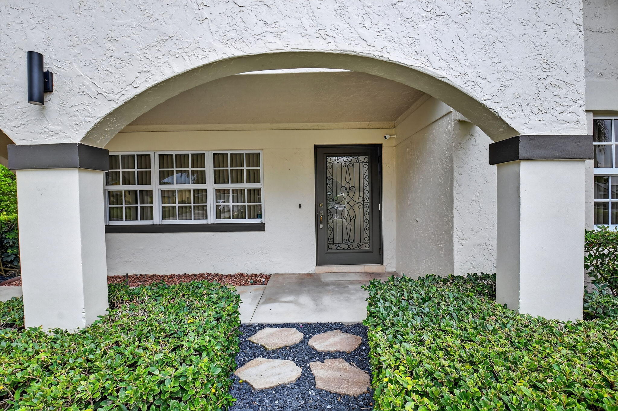 360 Northwest 53rd Street Boca Raton, FL 33487 - Photo 4 of 72 a front view of a house with garden