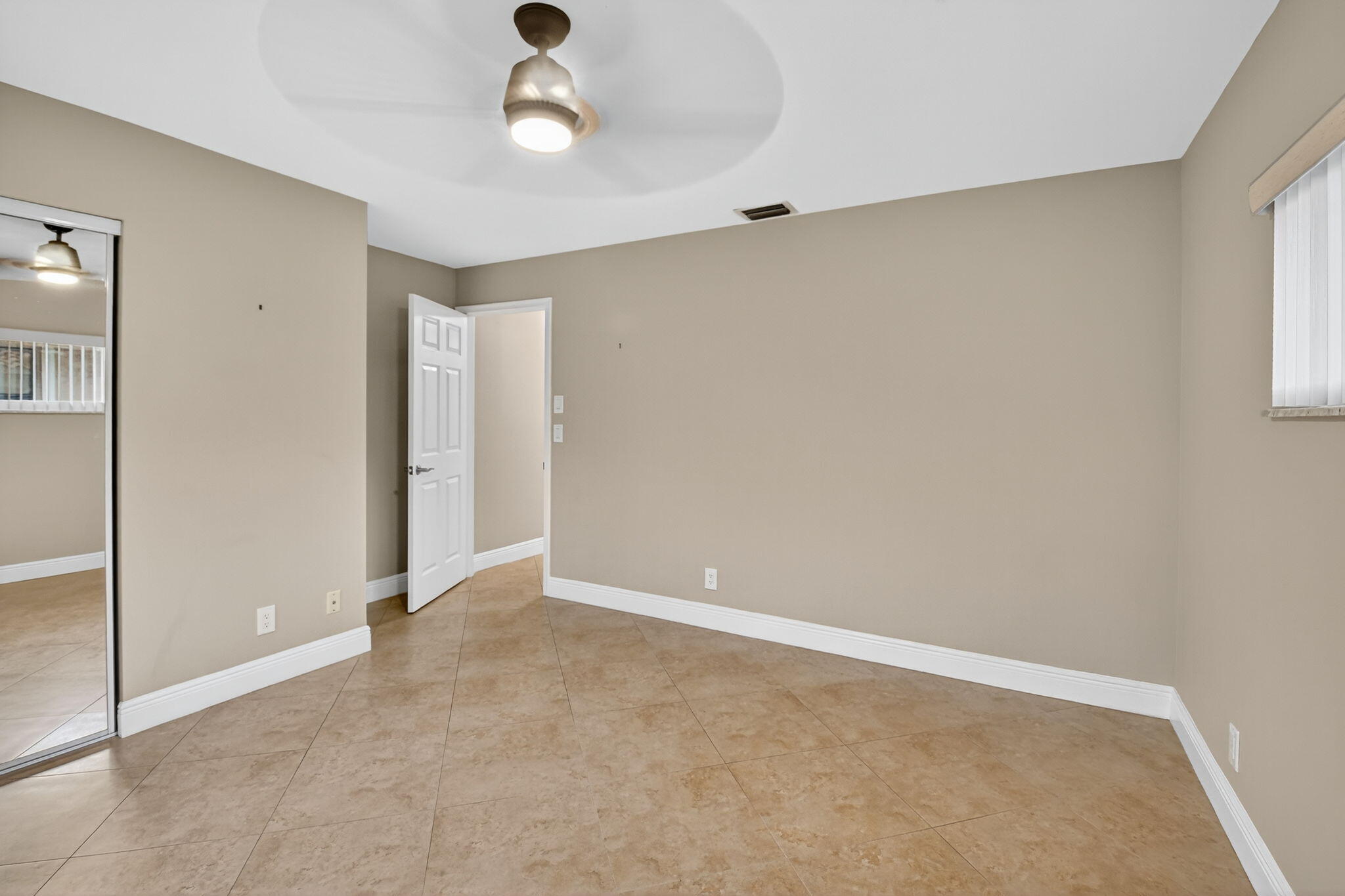 360 Northwest 53rd Street Boca Raton, FL 33487 - Photo 48 of 72 wooden floor in an empty room with a window