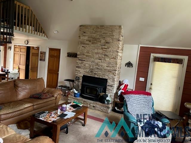 27 Golf Drive Rociada, NM 87742 - Photo 5 of 10 Carpeted living area featuring a fireplace and high vaulted ceiling