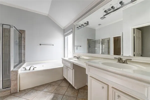 a bathroom with a tub sink and mirror