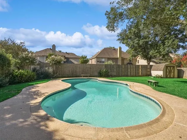 a view of a swimming pool with a garden