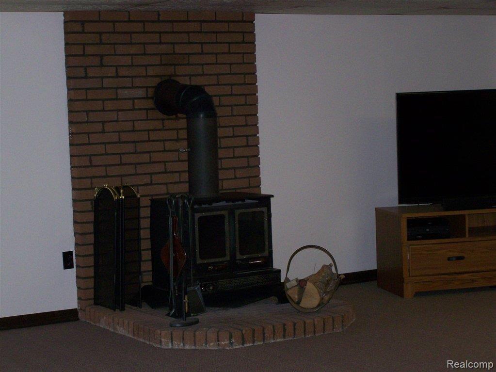 1294 Peavy Road Howell, MI 48843 - Photo 17 of 28 CLOSER VIEW OF WOOD BURNER